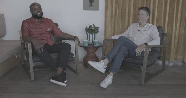 Two guests in conversation on the set of the Flow podcast