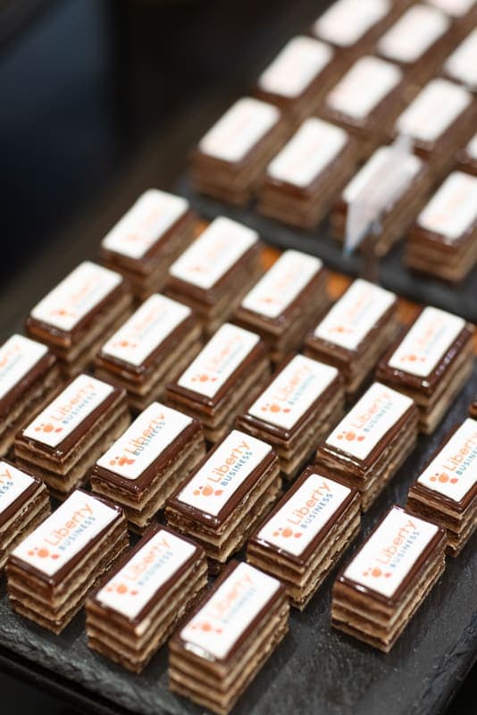 Petits fours topped with the Liberty Business logo