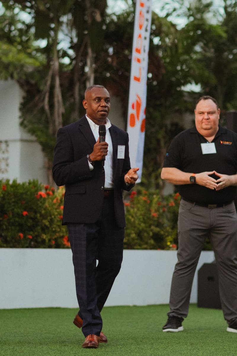Speakers addressing guests at the Liberty Business and Fortinet reception on the lawn