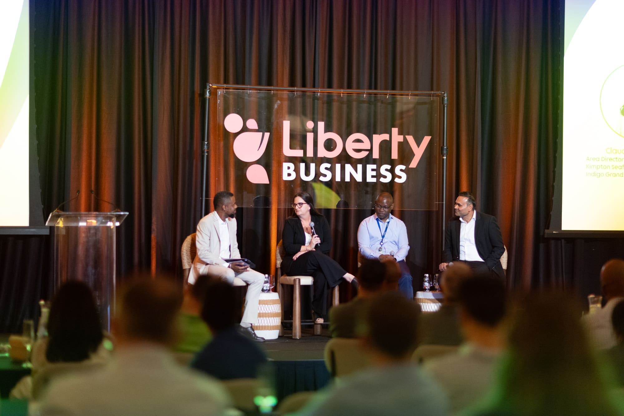 A panel discussion on the Liberty Business stage in front of a full room